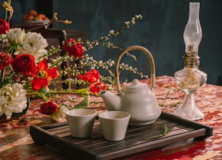 white ceramic teapot on brown wooden tray