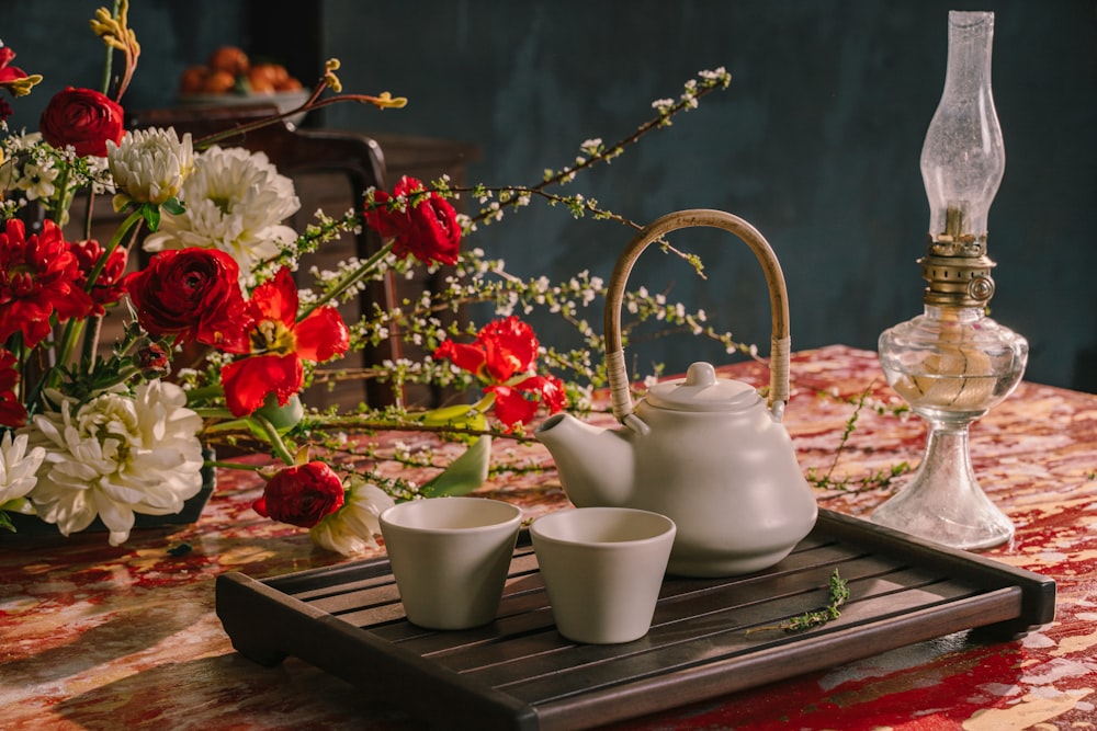 white ceramic teapot on brown wooden tray