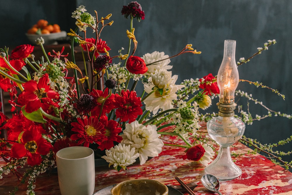 red and white roses in clear glass vase