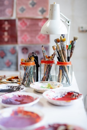 white ceramic plate with paint brushes and paint brushes