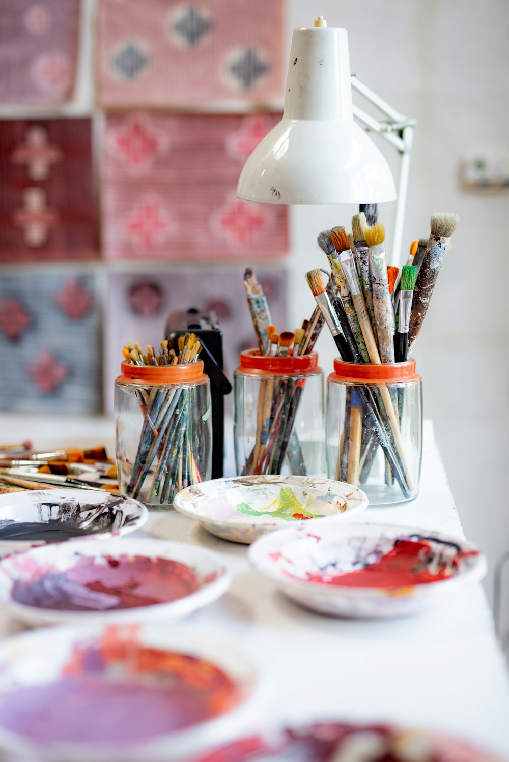 white ceramic plate with paint brushes and paint brushes