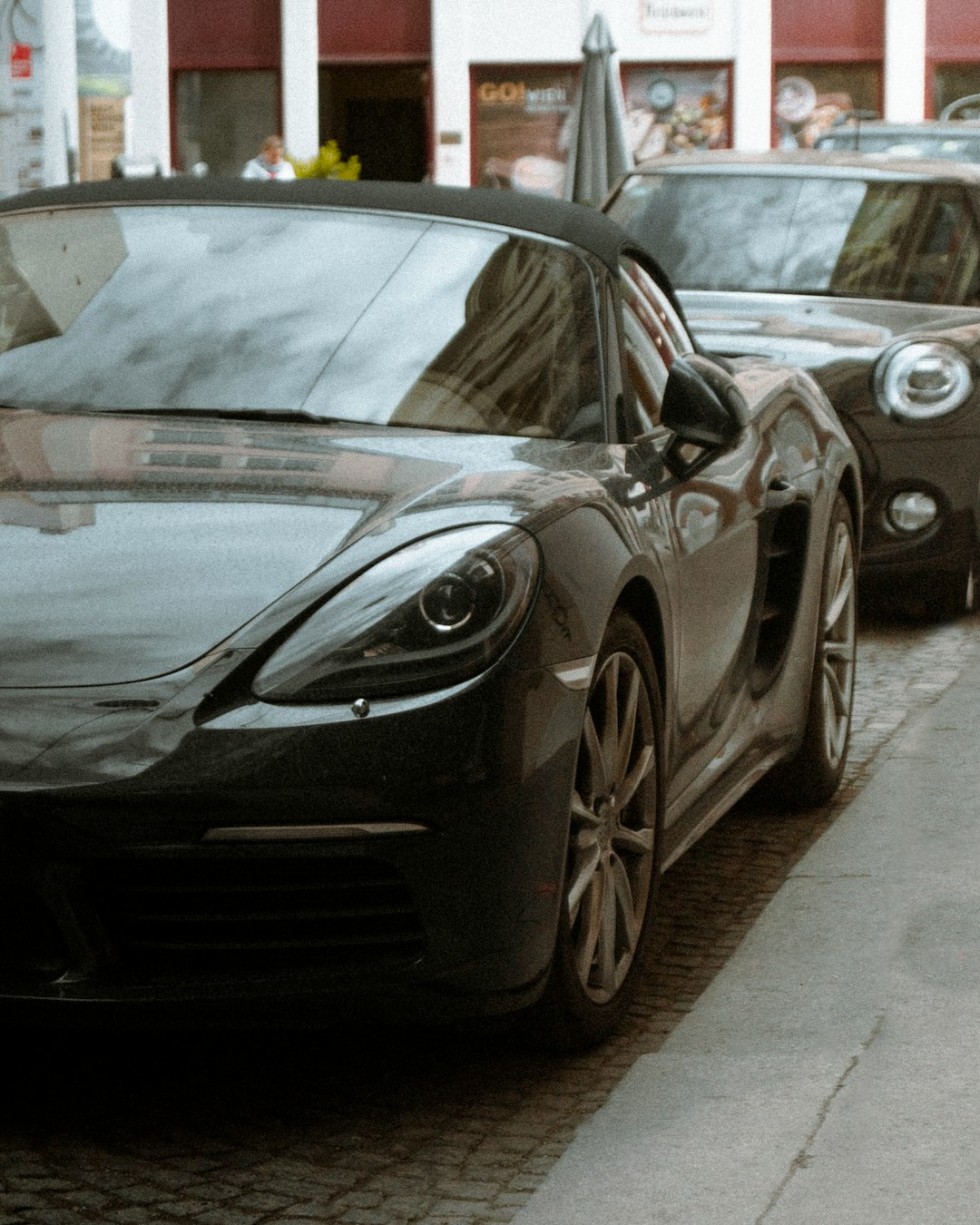 black porsche 911 parked on parking lot during daytime