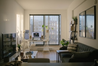 black leather sofa near glass window