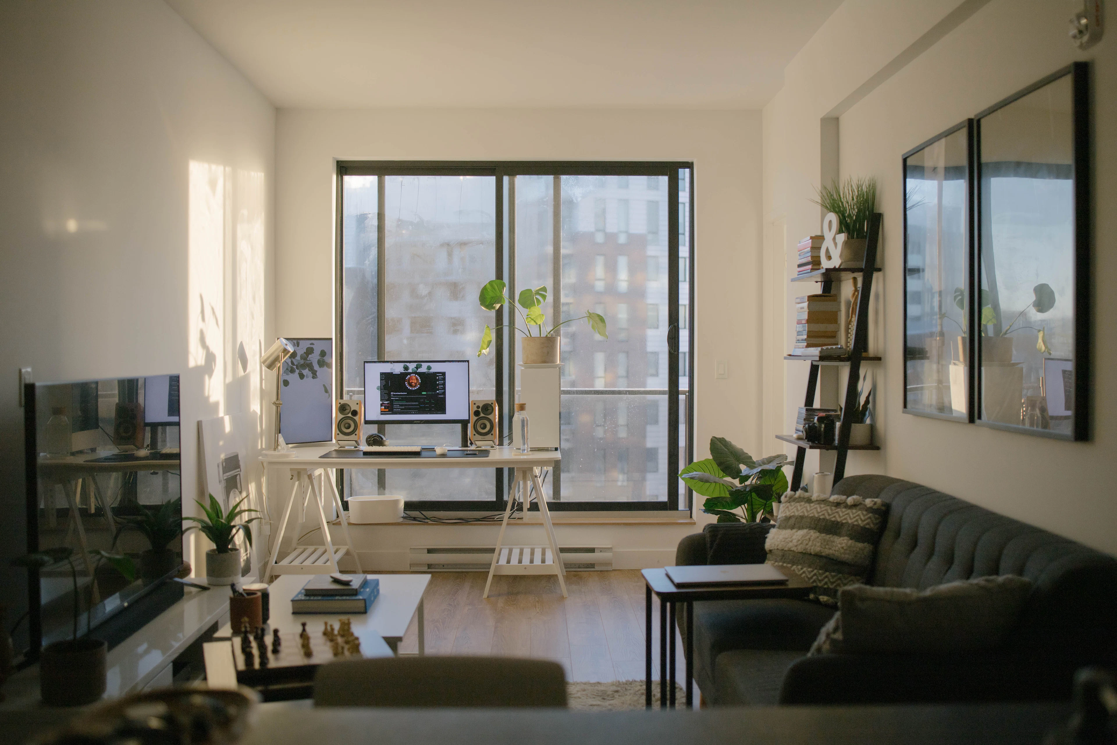 Sunlit room with a desk, a computer and a sofa