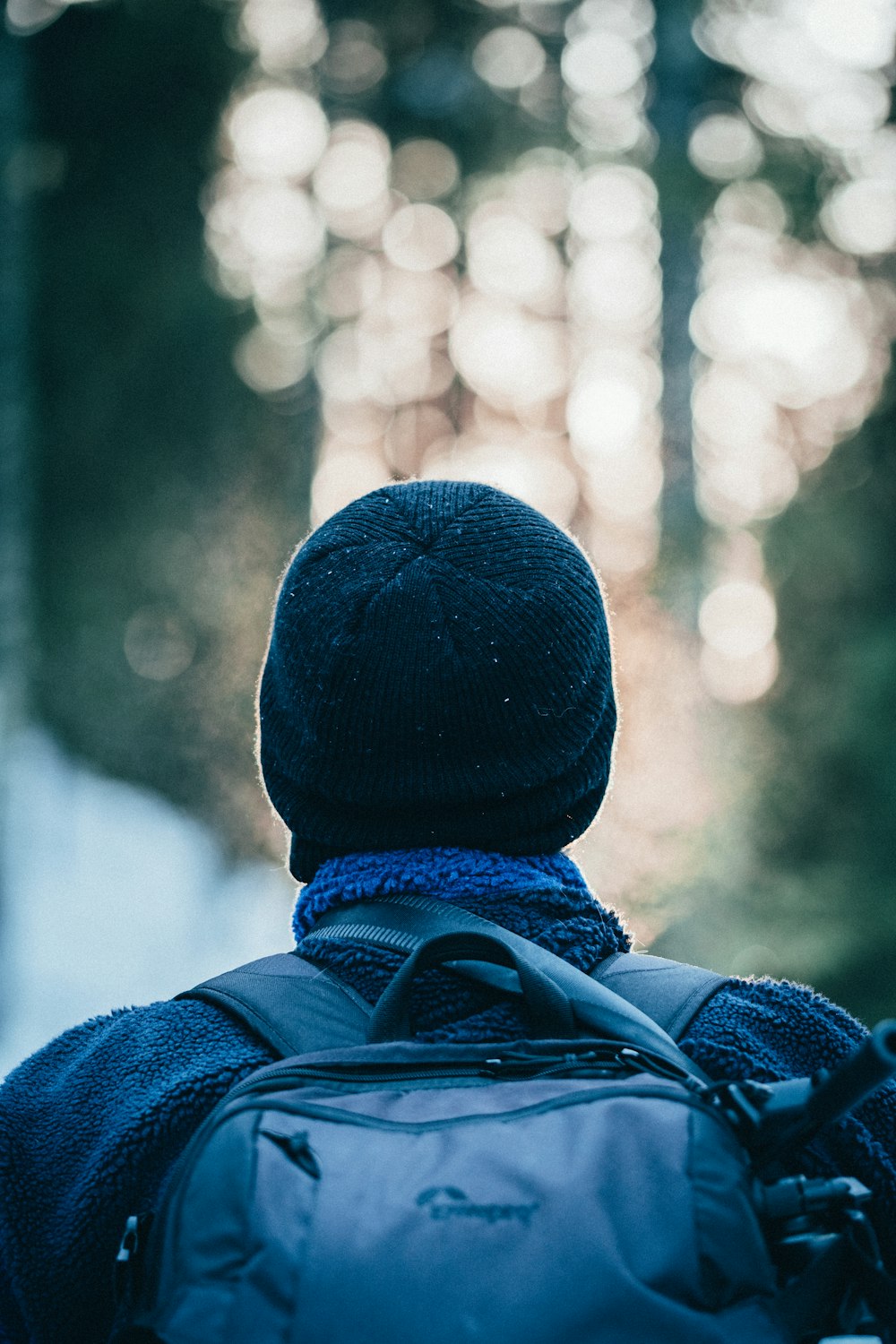 person in blue knit cap and blue jacket