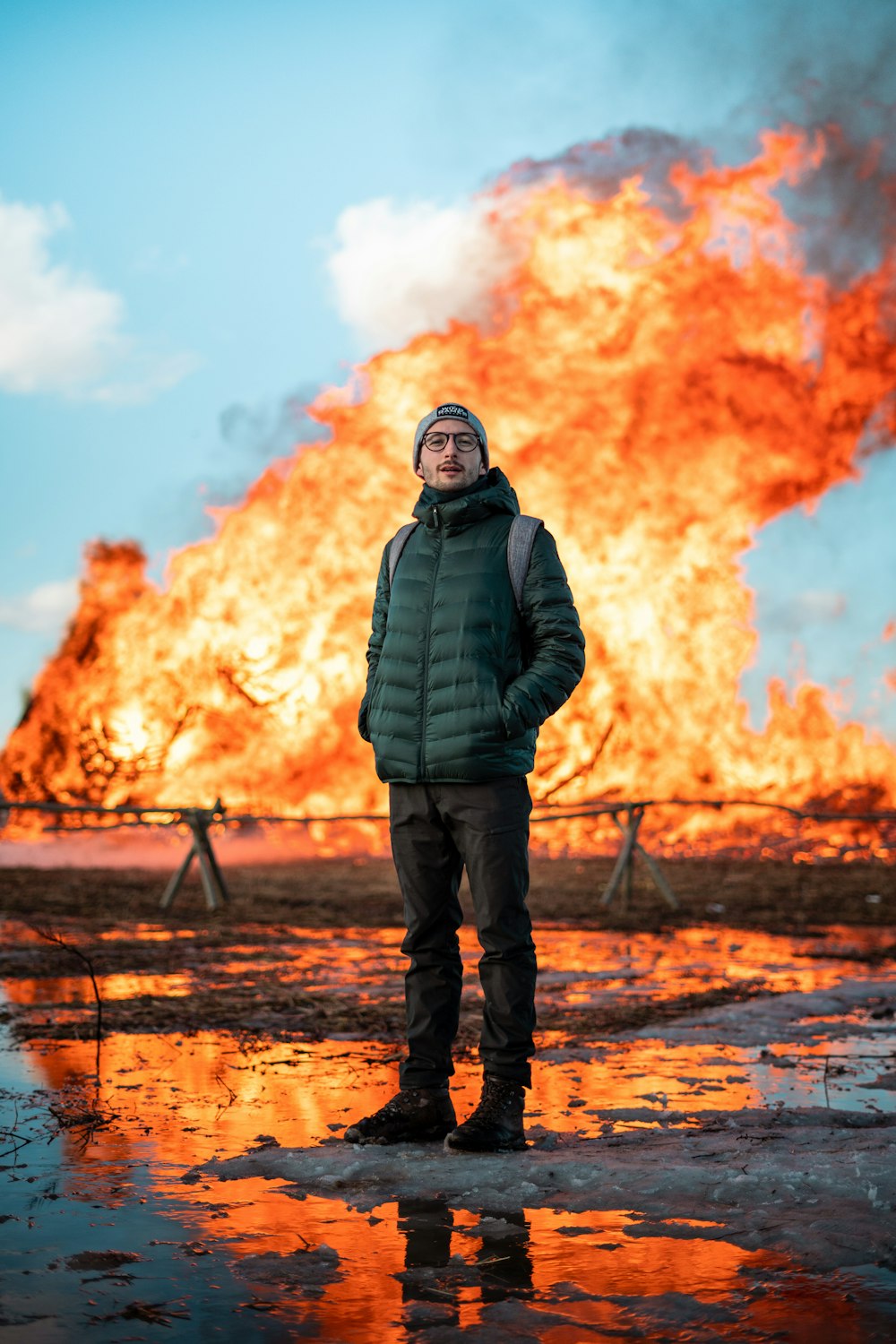 man in black jacket standing on brown field during daytime