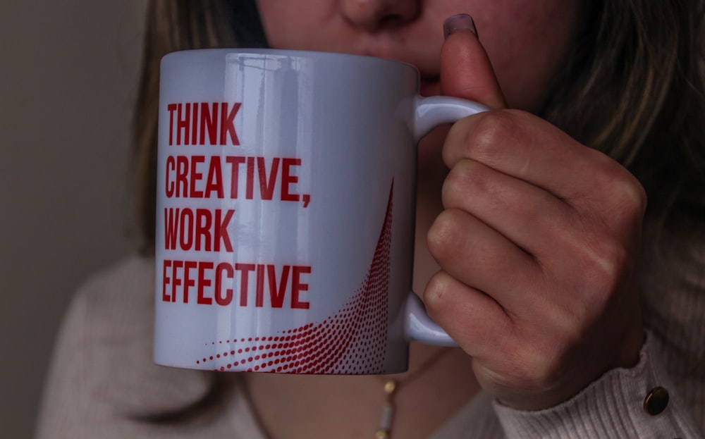 white and red ceramic mug