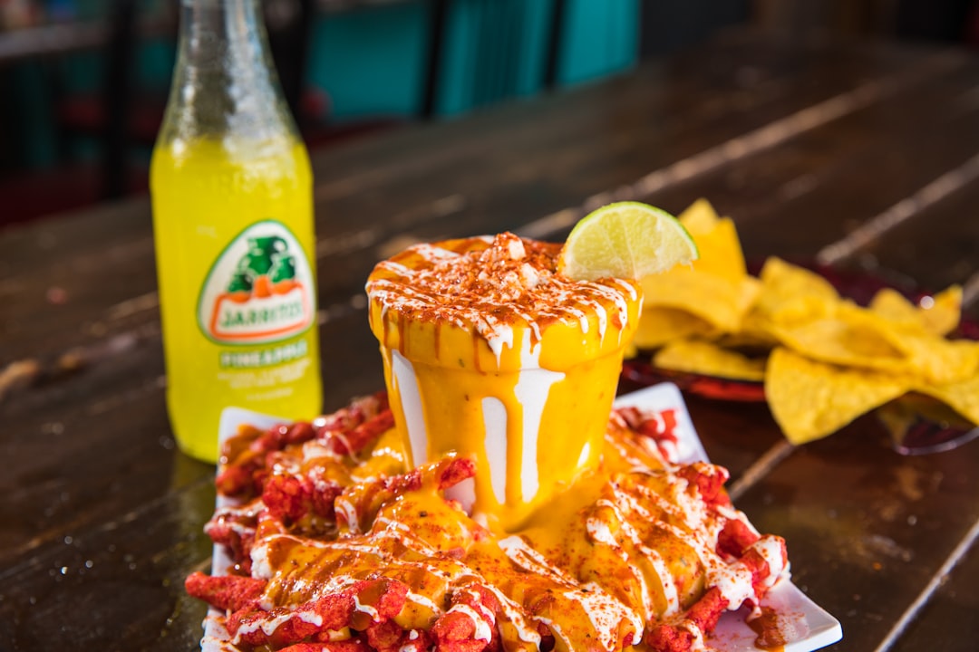 yellow and red labeled plastic cup, Jarritos and vaso de elote
