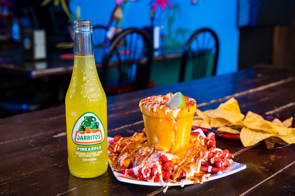 yellow plastic bottle beside white ceramic plate with food