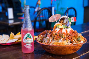 A festive table setting with various Mexican snacks including esquites and elotes, ready for a family gathering.