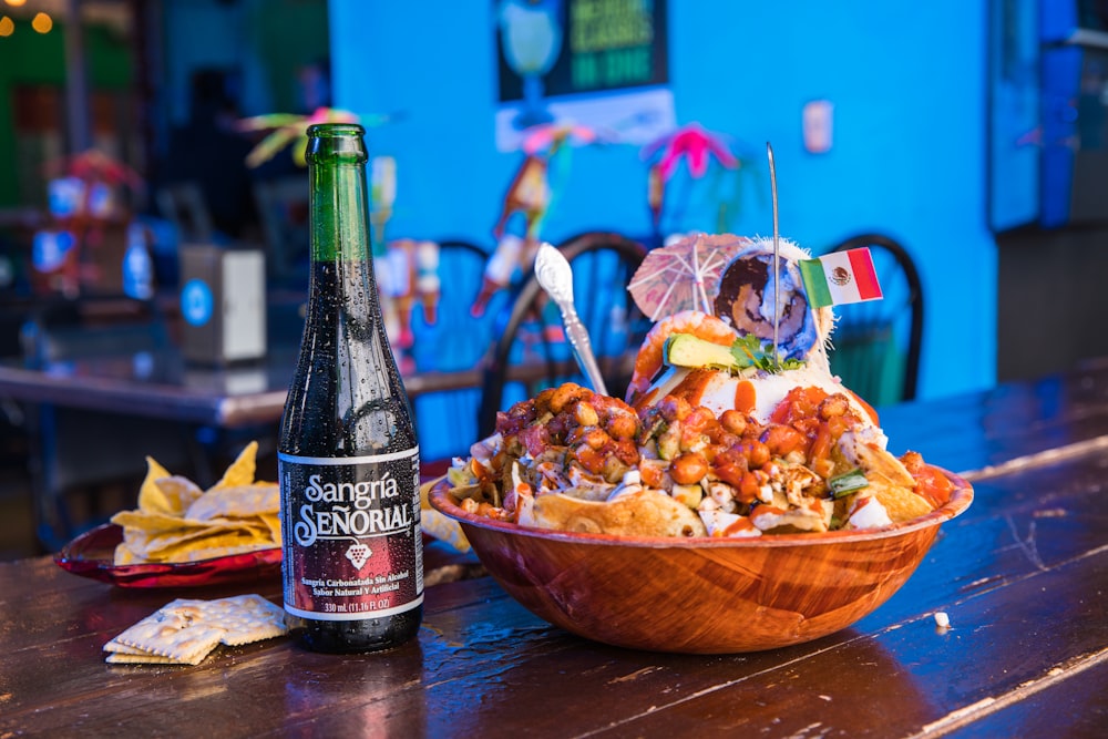 brown wooden bowl with chips and bottle