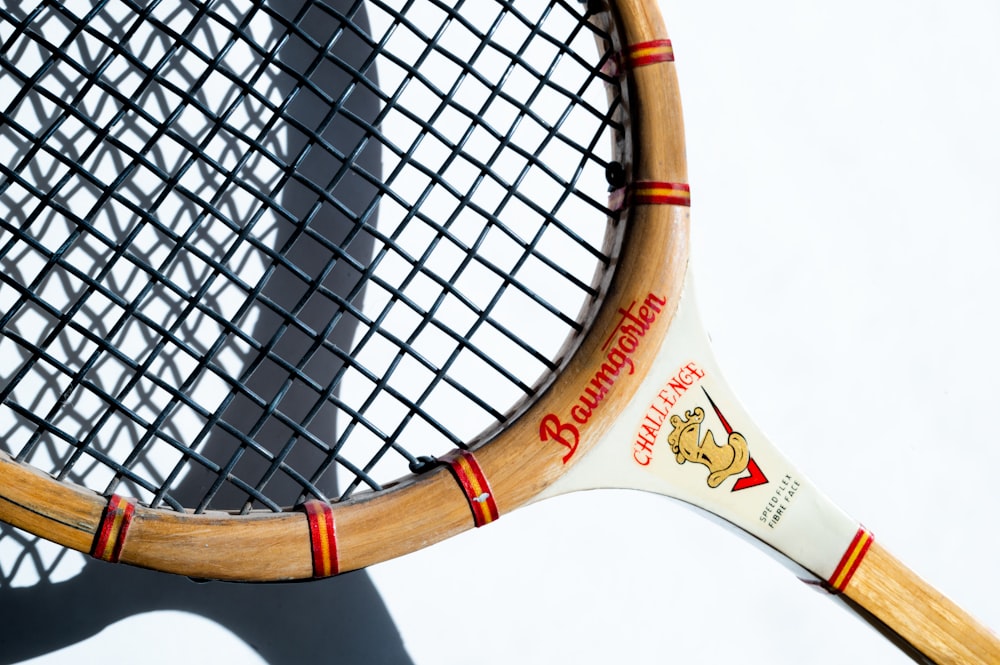 white and brown tennis racket