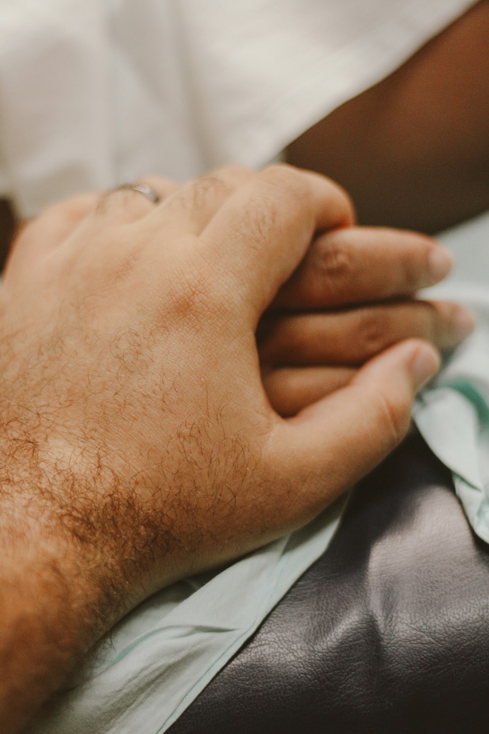 persons hand on white textile