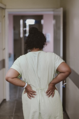 woman in white dress standing near white wall