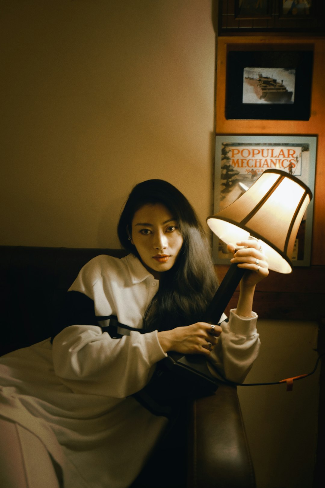 woman in white long sleeve shirt sitting on bed