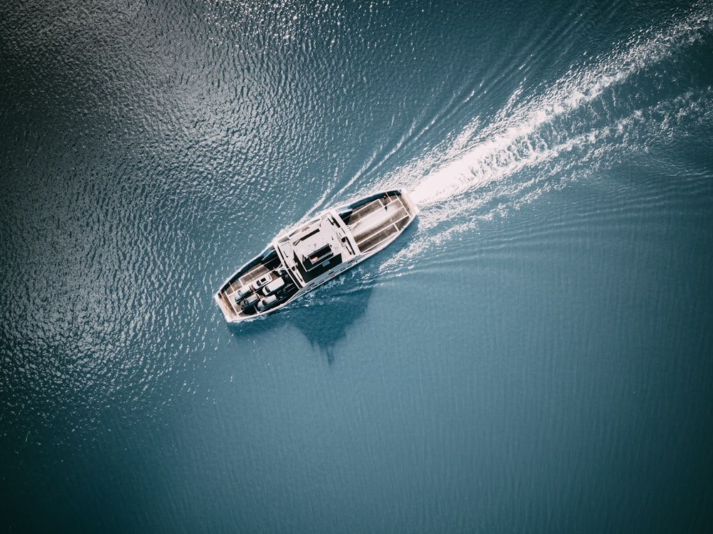 white and brown boat on blue sea water during daytime