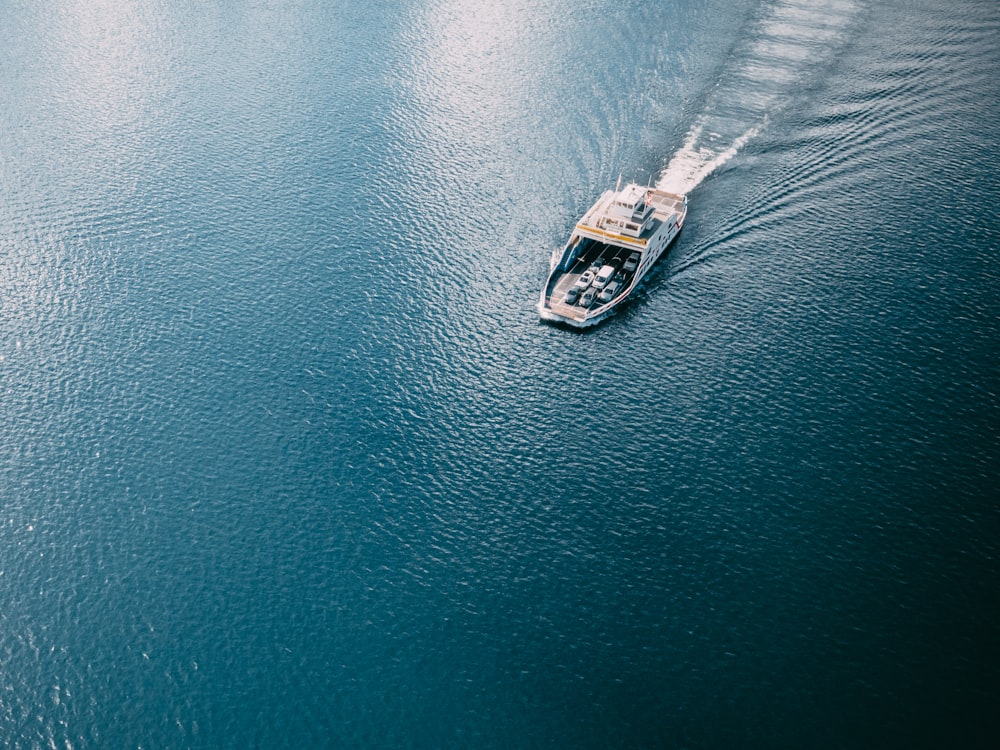 white and black boat on body of water during daytime