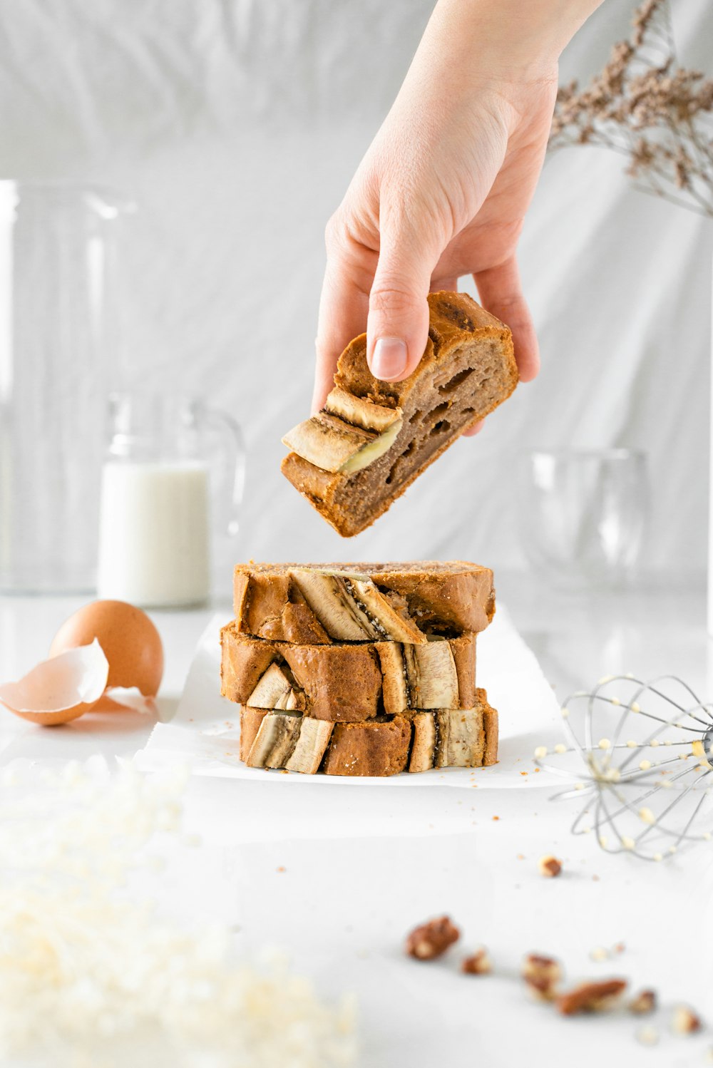 person holding brown cookies on white table