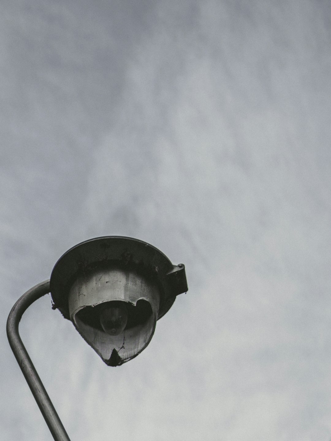 black and white street lamp under white clouds