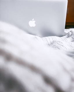 An atmospheric scene featuring a macbook illuminated by natural light.