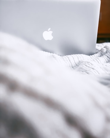 An atmospheric scene featuring a macbook illuminated by natural light.
