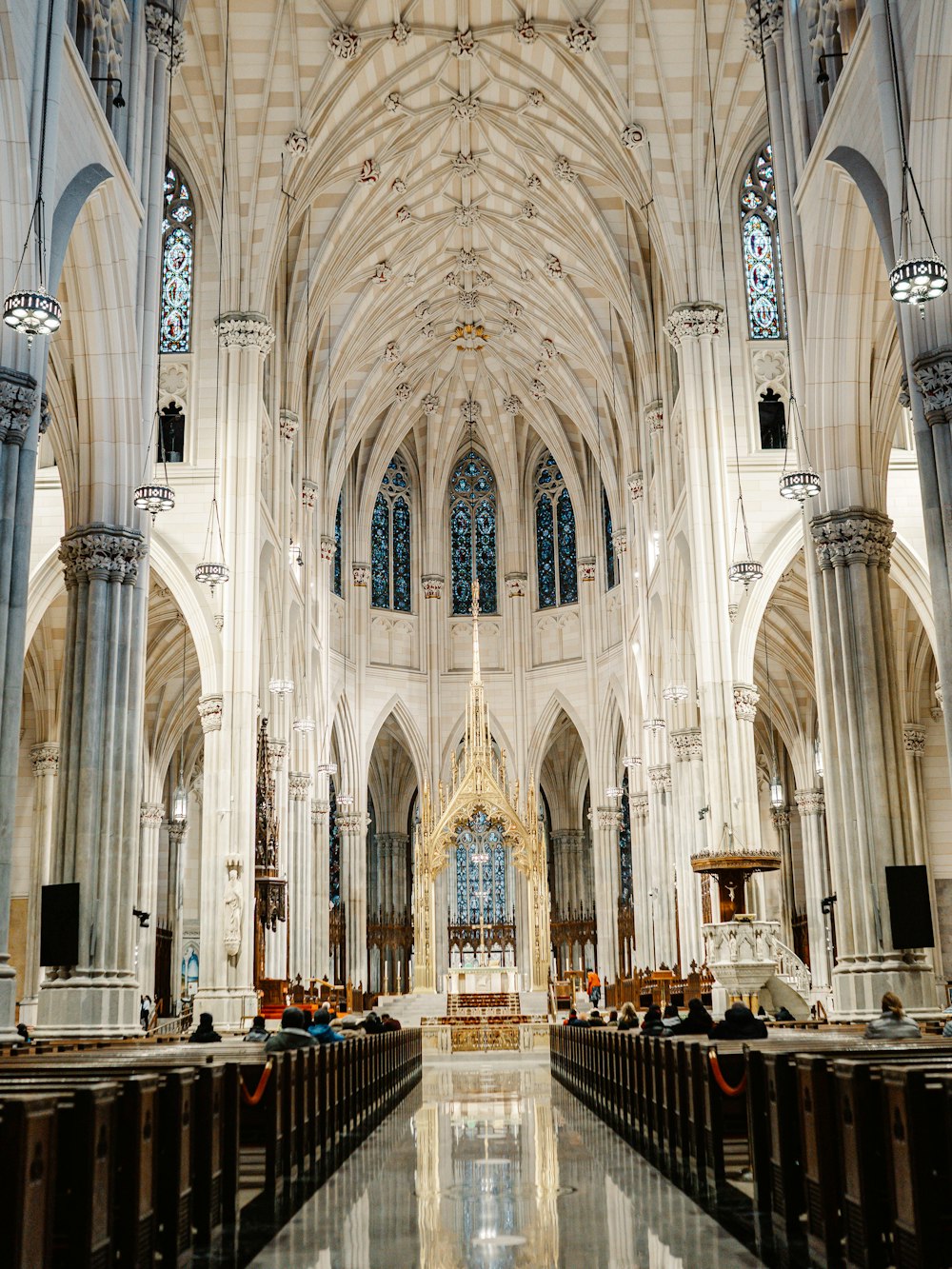 people sitting on bench inside cathedral