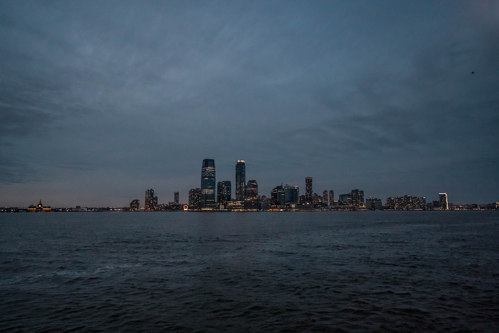 city skyline across body of water during daytime