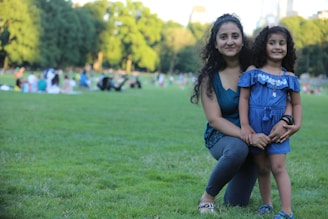 Smiling mother and child enjoying time together in a park.