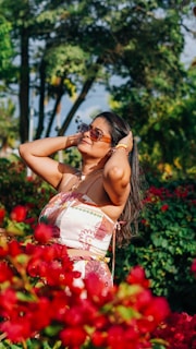 A vibrant and elegant woman enjoying a sunny day outdoors.