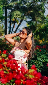 A vibrant and elegant woman enjoying a sunny day outdoors.