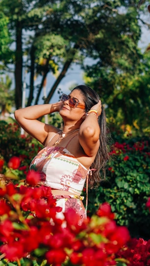 A woman enjoying a sunny day wearing a flowy amuxx dress with the brand's signature logo.