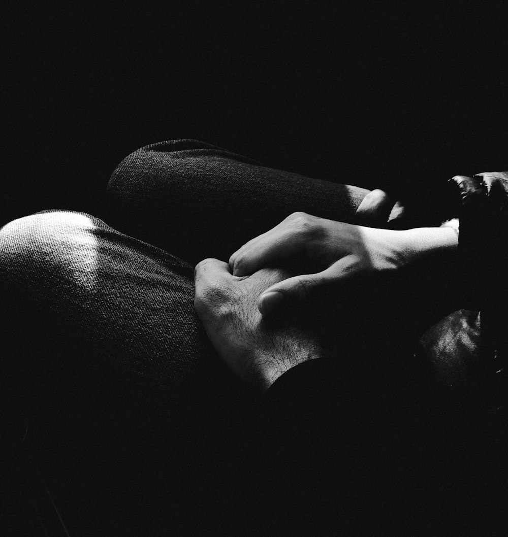 grayscale photo of persons feet on sofa