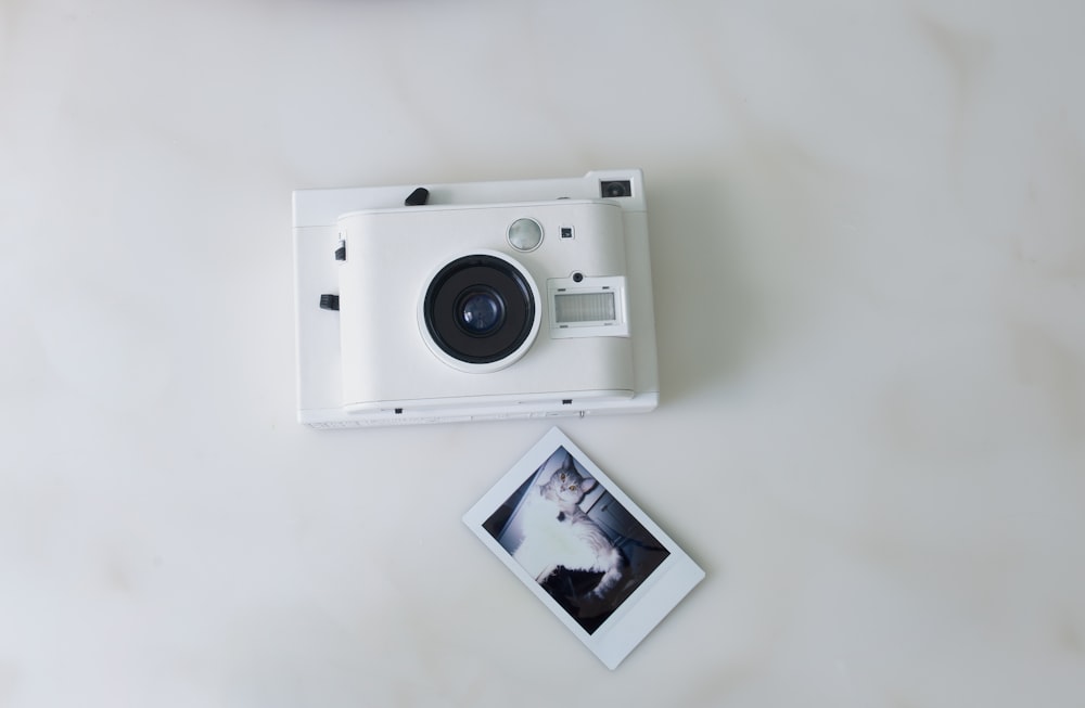 white and black camera on white table
