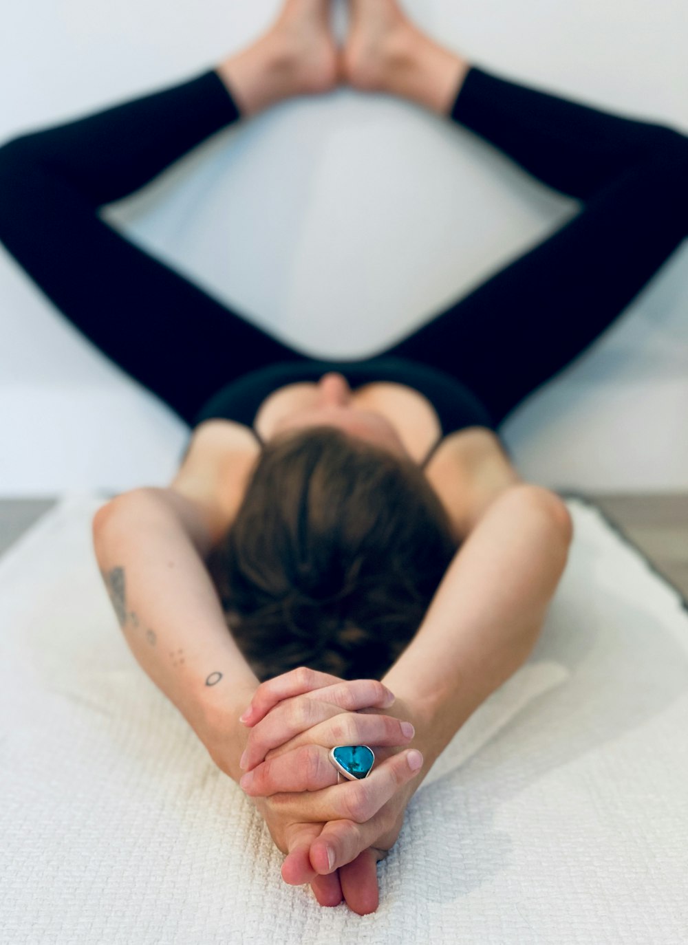 woman in black tank top lying on bed