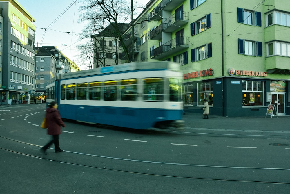 white and blue train on rail road during daytime