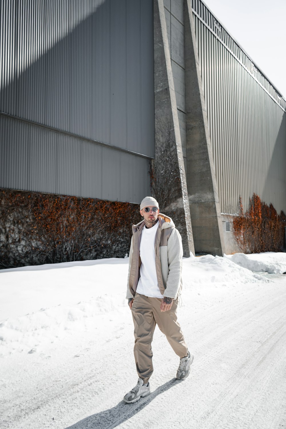 man in white coat standing on snow covered ground