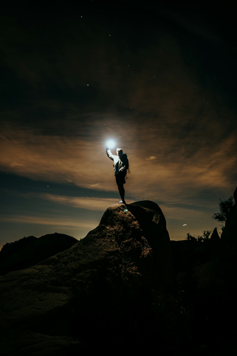 man standing on rock during night time
