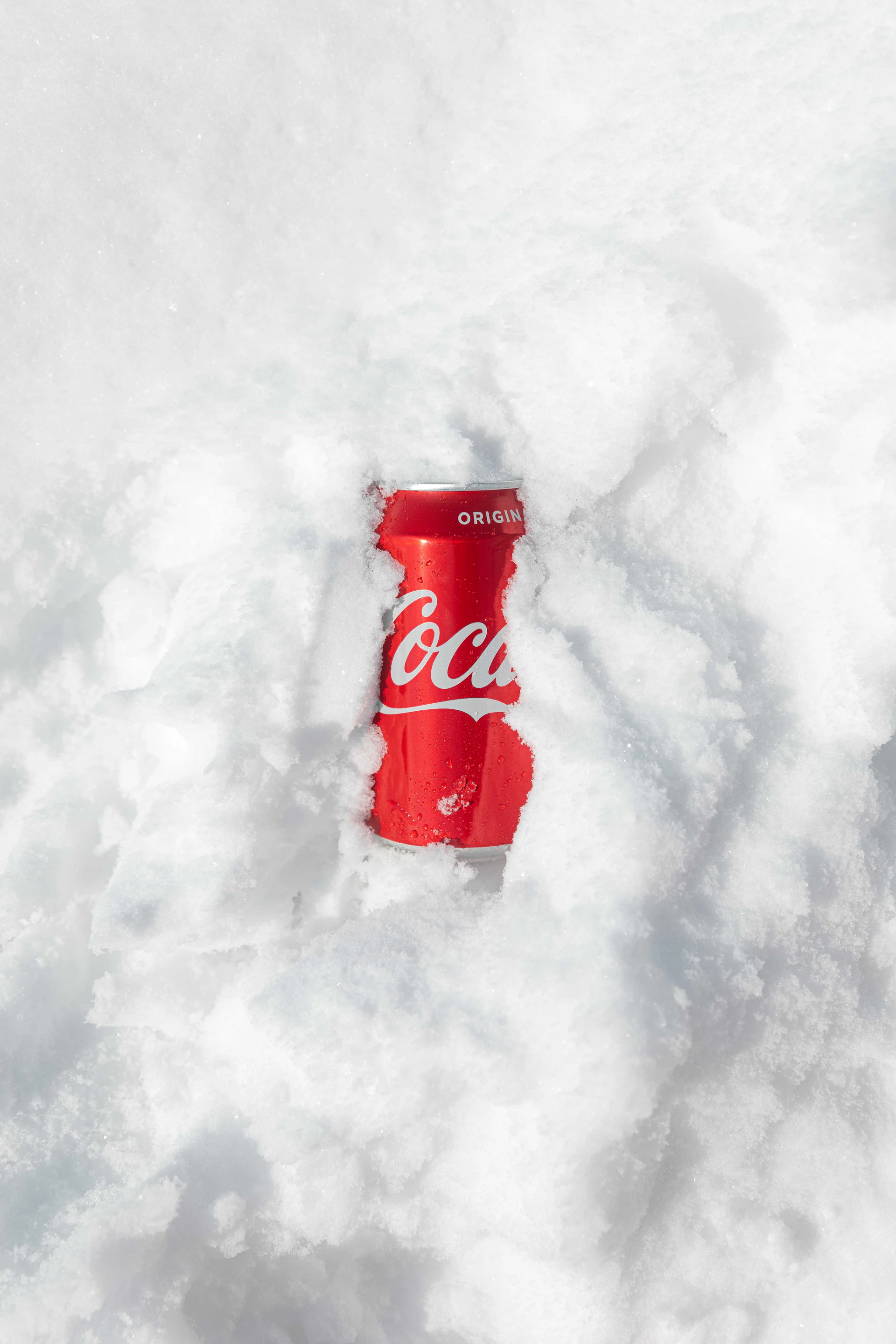 red coca cola can on snow