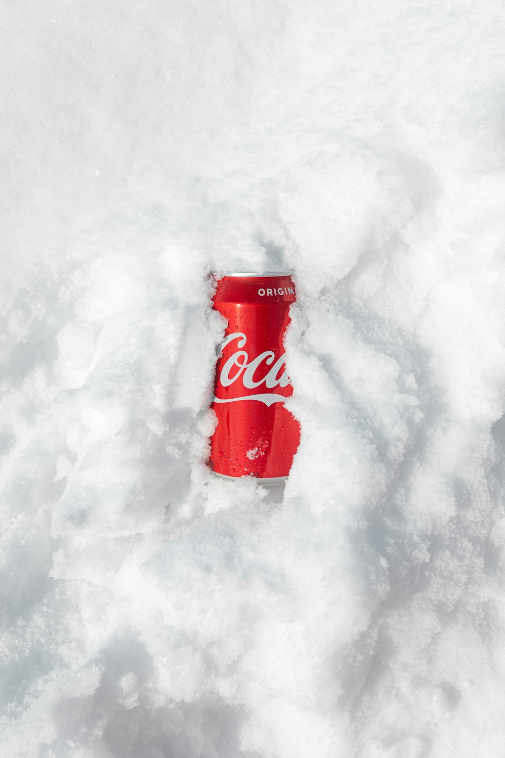 red coca cola can on snow