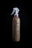 A repellent spray can against a black backdrop.