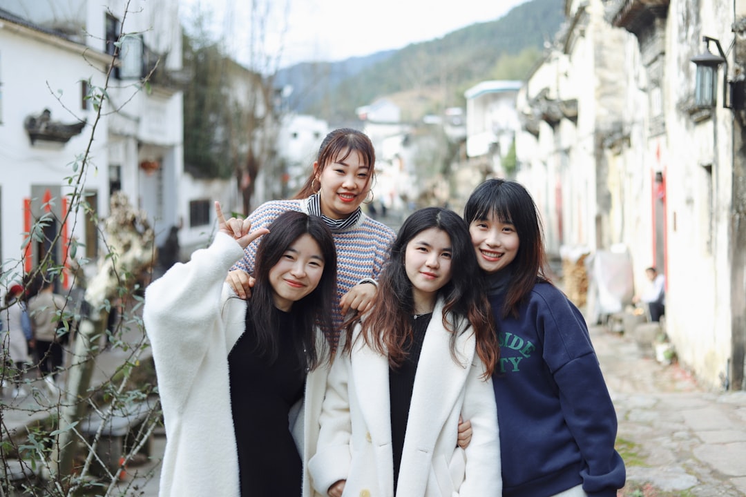 3 women in white coat smiling