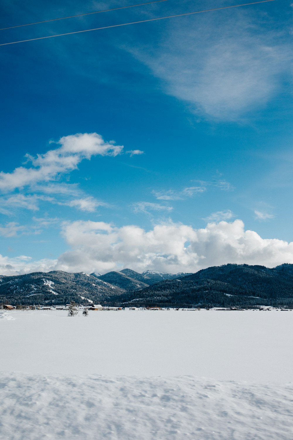 snow covered mountain under blue sky and white clouds during daytime