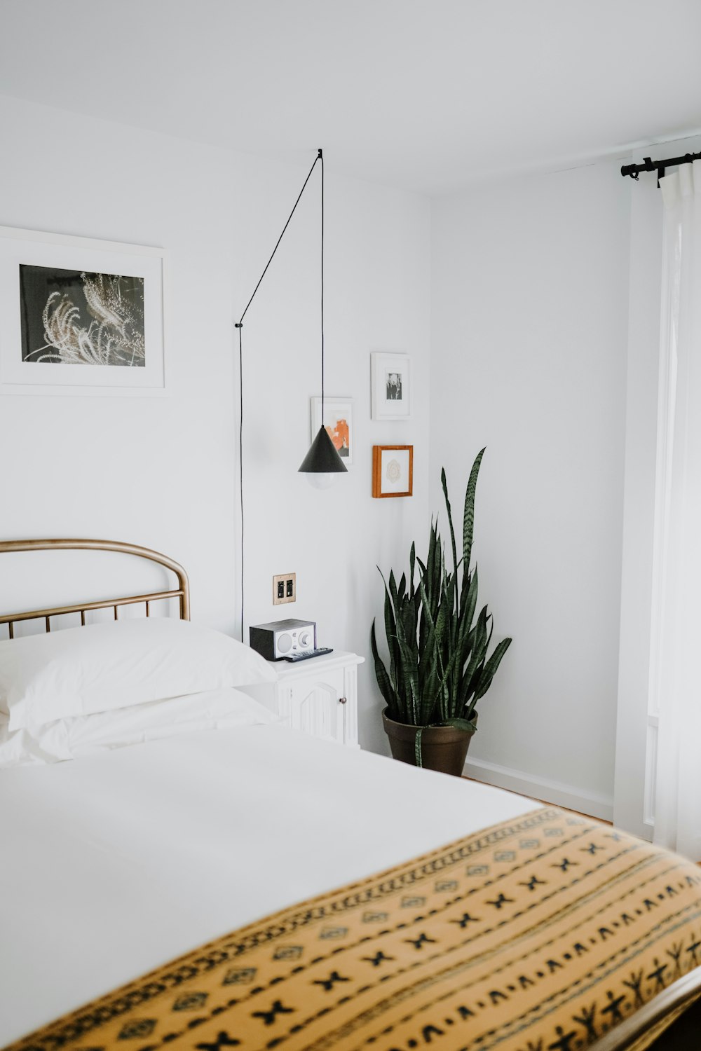 white bed linen near green potted plant