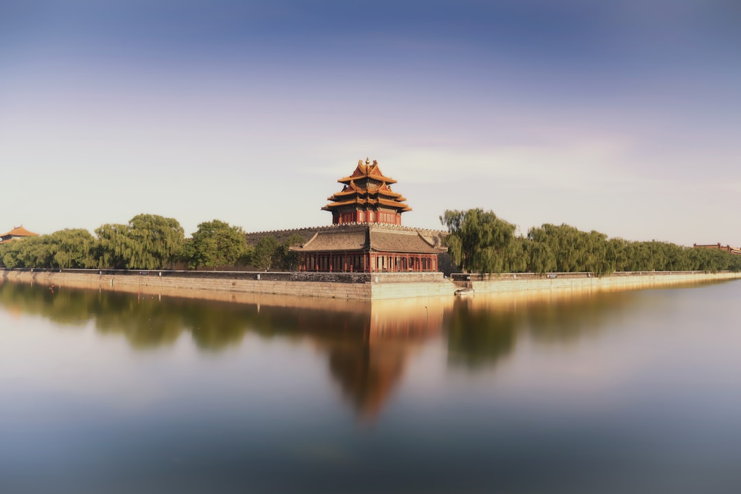 brown temple near lake under blue sky during daytime