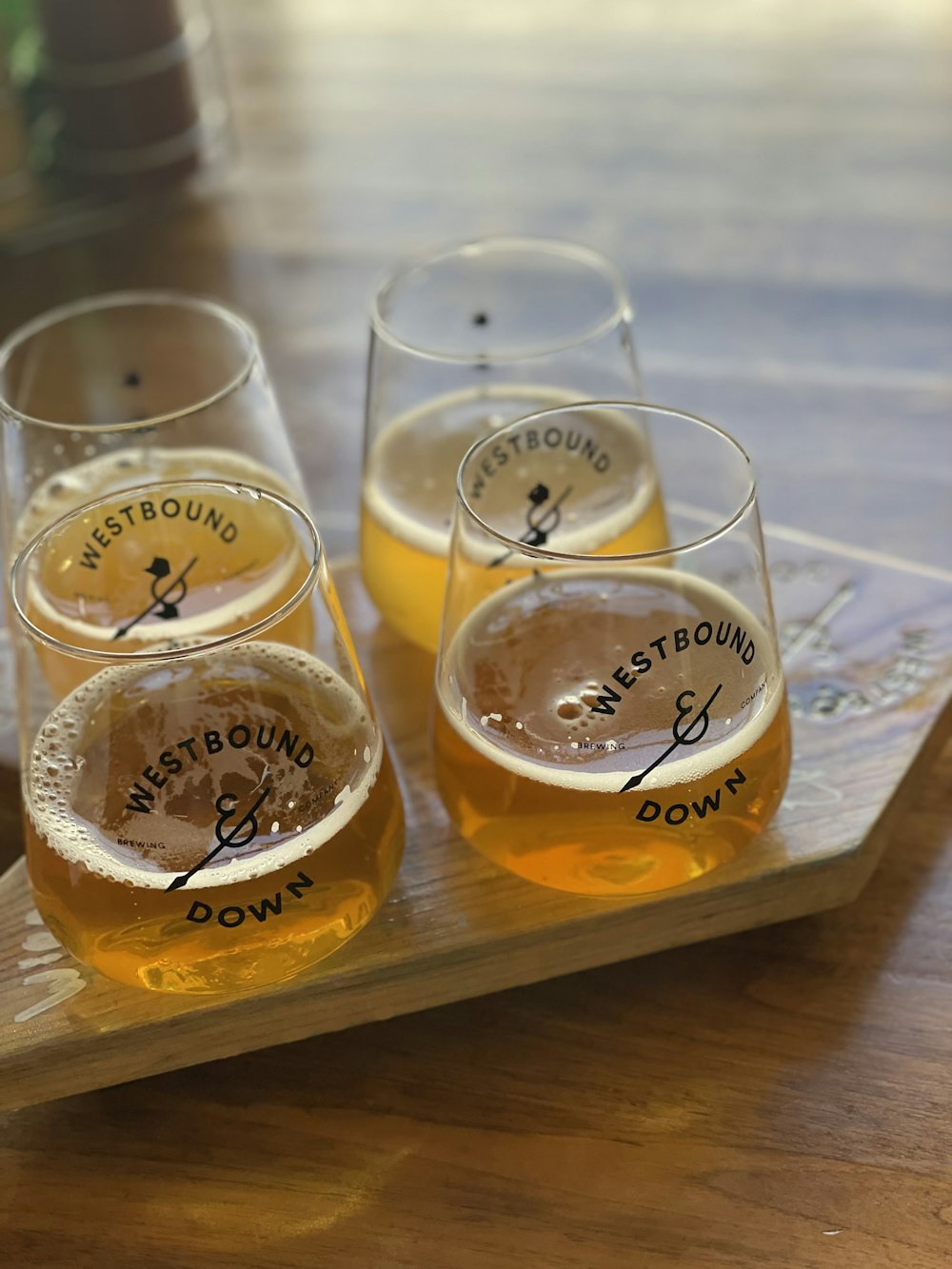 3 clear drinking glasses on brown wooden table