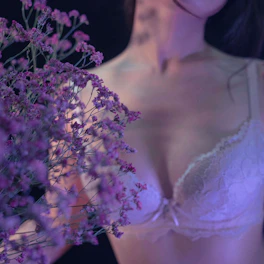 Close-up of delicate lace underwear in soft purple tones.