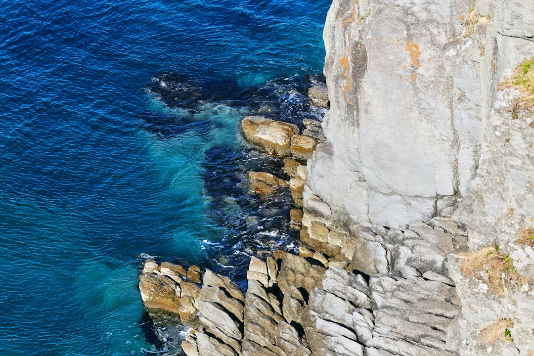 gray rock formation beside blue sea during daytime