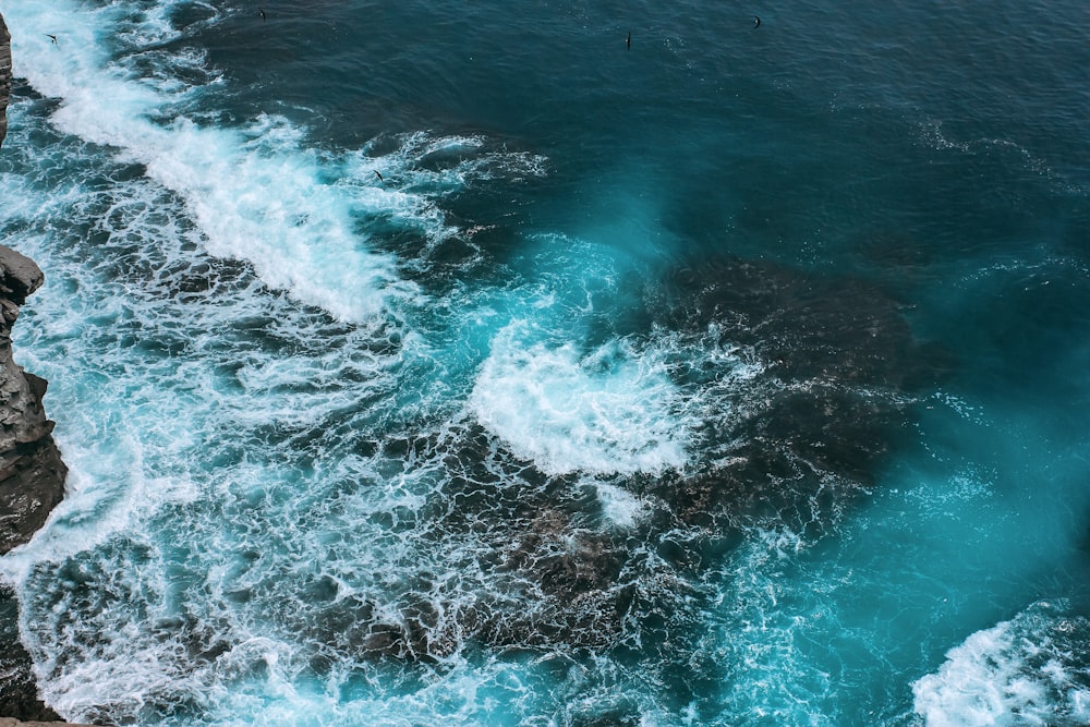 ocean waves crashing on shore during daytime