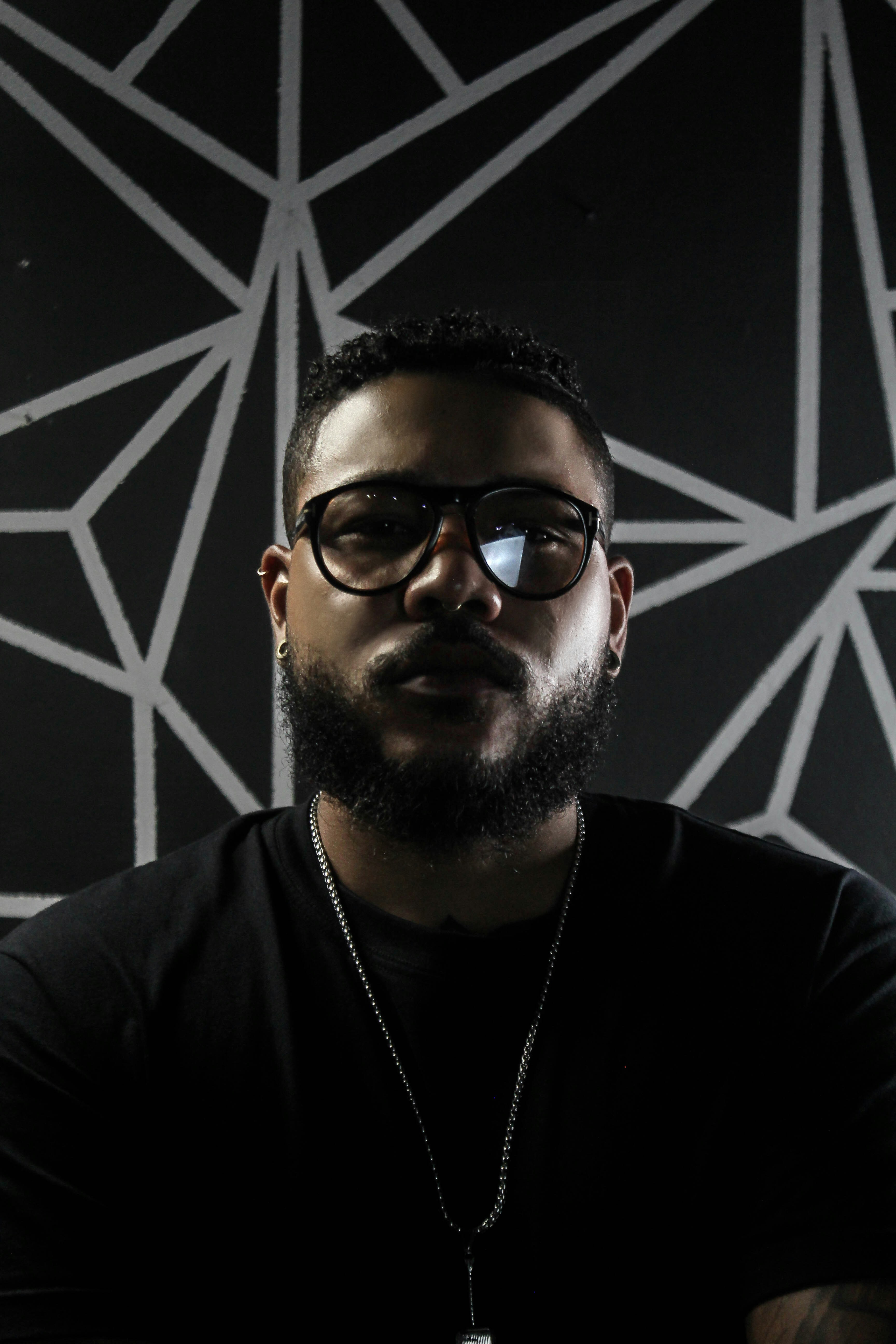 man in black crew neck shirt wearing black sunglasses