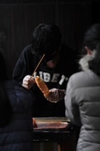 A friendly team member at tibanhoki ready to assist with a warm smile.